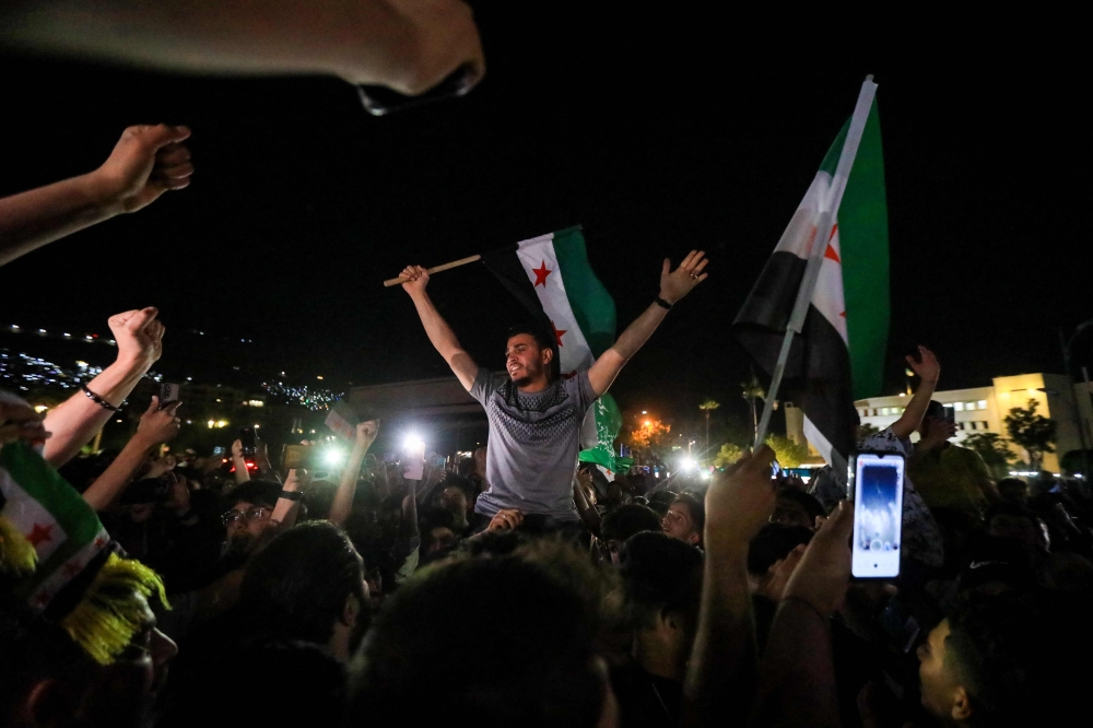People celebrate in Omeyyad Square after US President Donald Trump’s decision to lift sanctions, Damascus, Syria May 13, 2025. — AFP pic