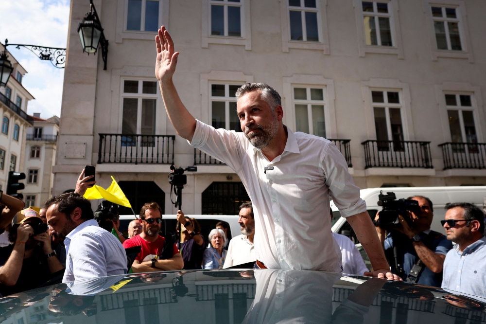 Portuguese Socialist Party (PS) leader Pedro Nuno Santos waves to supporters as he takes part in a street rally in Lisbon on May 16. — AFP pic
