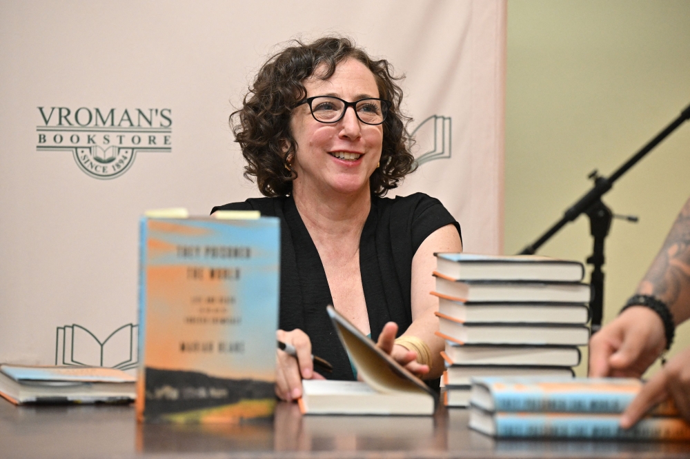 Mariah Blake, author of the new book ‘They Poisoned the World: Life and Death in the Age of Forever Chemicals’ signs copies in Vroman's Bookstore in Pasadena, California May 14, 2025. — AFP pic