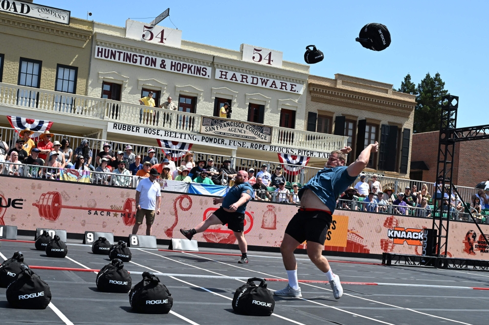 Rayno Nel of South Africa (right) and Lucas Hatton of the US (left) compete in the Titan's Toss competition on day two of qualifying at the ‘World's Strongest Man’ competition on May 16, 2025 in Sacramento, California. — AFP pic