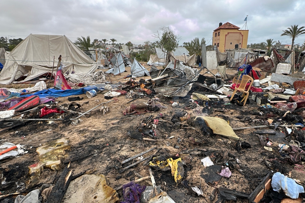 Charred debris is scattered on the ground at the site of Israeli strikes on a displacement tent camp, in the Mawasi area west of Khan Yunis in the southern Gaza Strip on May 18, 2025. — AFP pic