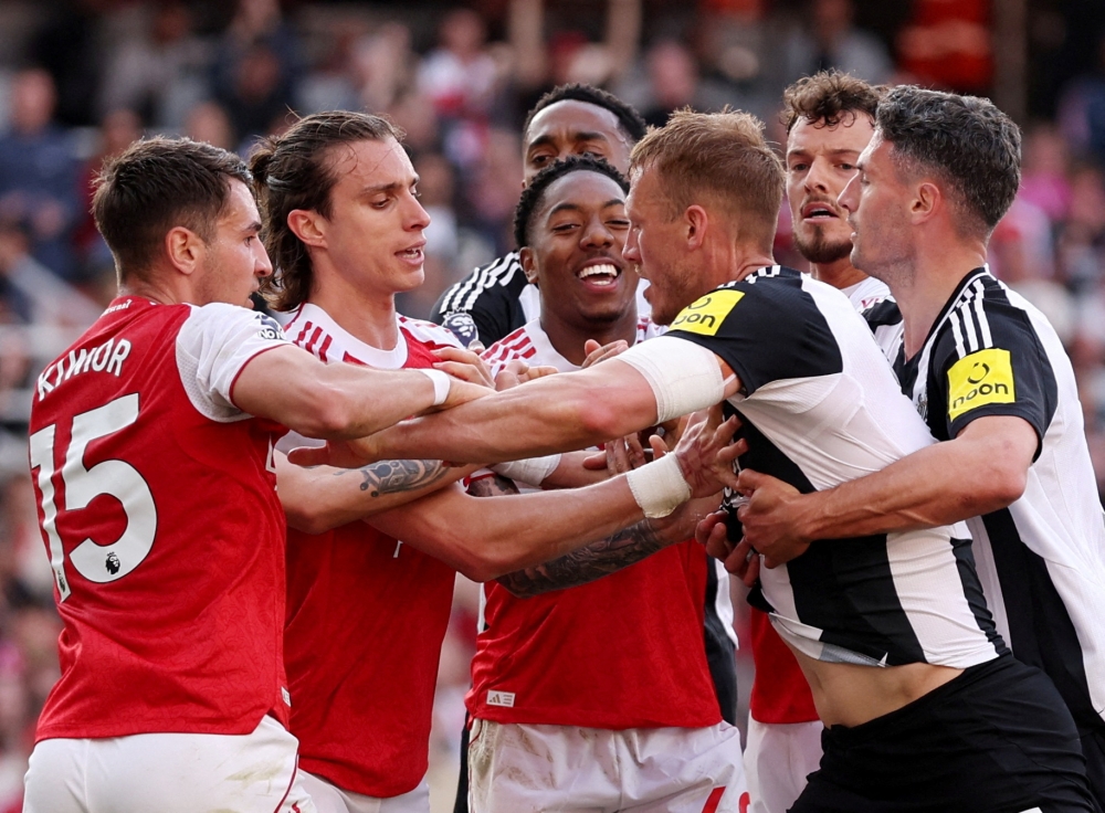 Arsenal's Jakub Kiwior, Riccardo Calafiori and Myles Lewis-Skelly clashes with Newcastle United's Dan Burn and Fabian Schar. — Reuters pic