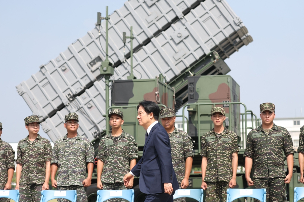 Taiwan's President Lai Ching-te walks past soldiers at a naval base following Chinese military drills earlier in the week, in Taoyuan on October 18, 2024. — AFP pic