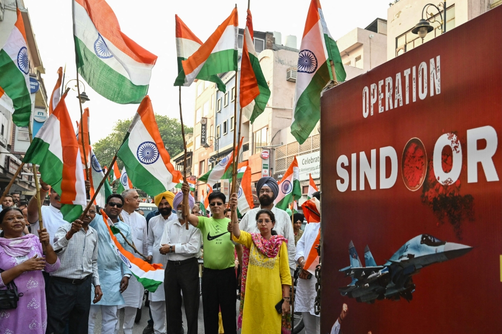 Bharatiya Janata Party (BJP) supporters waves Indian national flags during a Tiranga Yatra to celebrate the success of 'Operation Sindoor' and to express solidarity with Indian Army in Amritsar on May 17, 2025. — AFP pic