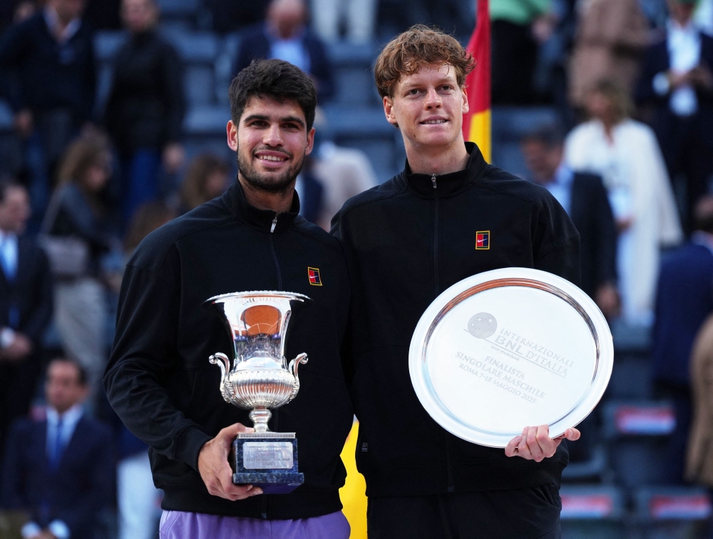 Spain’s Carlos Alcaraz poses for a photo with Italy’s Jannik Sinner after winning the final of the Italian Open in Rome May 18, 2025. — Reuters pic