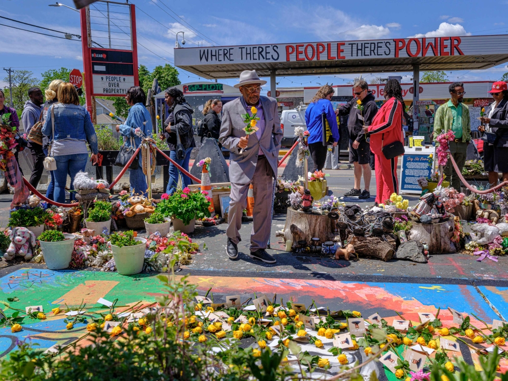 Community members and Floyd family members gather around a mural of George Floyd at George Floyd Square to leave yellow roses and photos in his memory in Minneapolis, Minnesota on May 23, 2025. — AFP pic