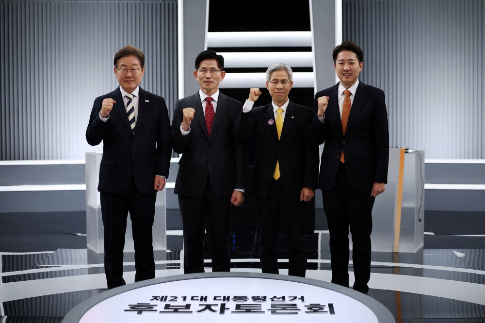 South Korea's presidential candidates, Kim Moon-soo of the People Power Party, Kwon Young-guk of the Democratic Labor Party, Lee Jun-seok of the New Reform Party and Lee Jae-myung of the Democratic Party pose for photograph ahead of the second televised debate for the upcoming presidential election in Seoul, South Korea May 23, 2025. — Reuters pic