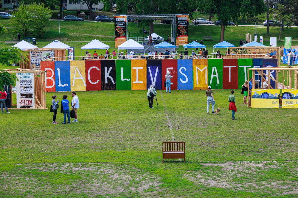 Visitors gather near a large “Black Lives Matter” and “I cant Breathe” murals at the Rise and Remember Festival in Minneapolis, Minnesota May 25, 2025. — AFP pic