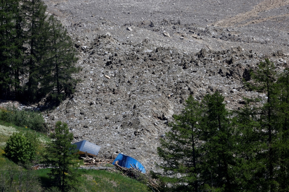Debris and dust from a partially collapsed glacier blanket Blatten, Switzerland. — Reuters pic