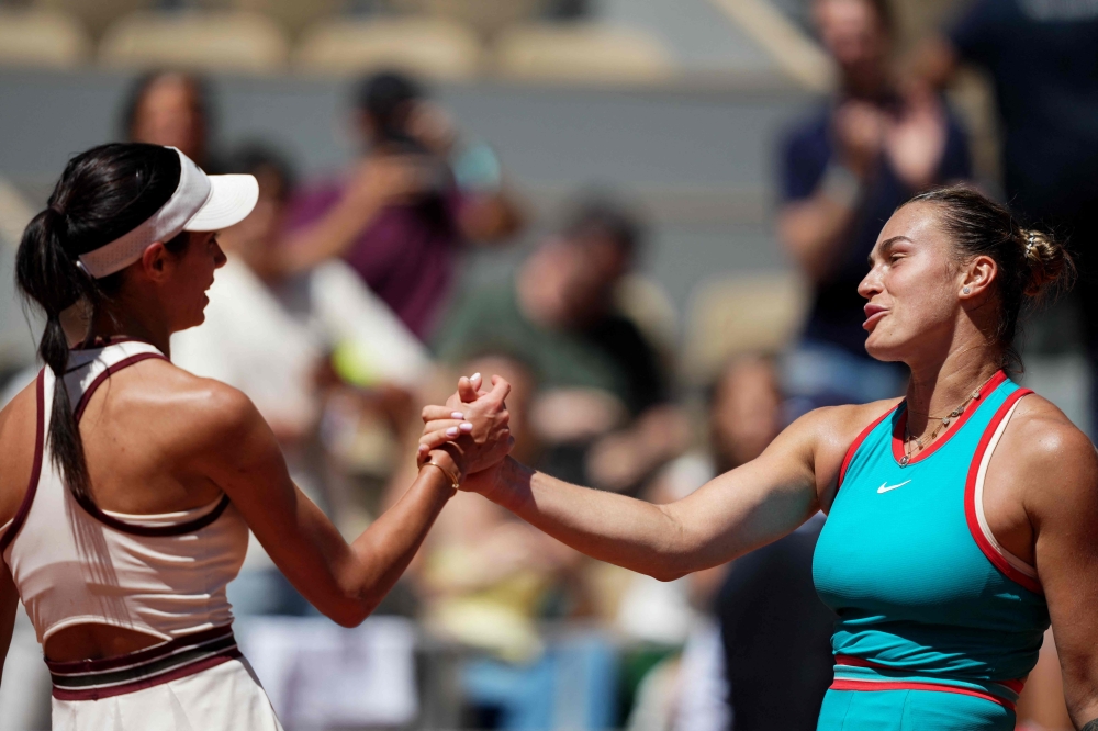 Belarus' Aryna Sabalenka (right) shakes hands with Serbia's Olga Danilovic after winning their women's singles match on day 6 of the French Open tennis tournament on Court Philippe-Chatrier at the Roland-Garros Complex in Paris May 30, 2025. — AFP pic