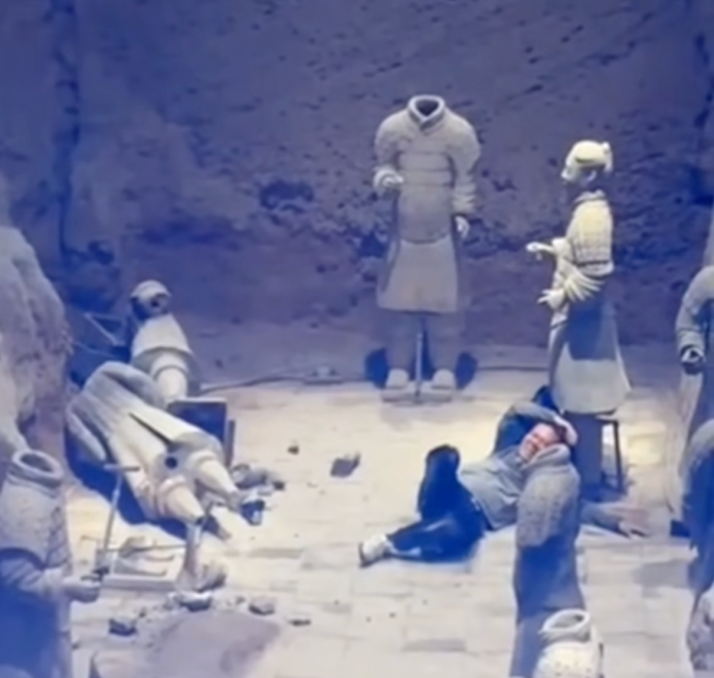 A screengrab from video of the man surnamed Sun after he had climbed over the guardrail and the protective net and jumped into the pit, damaging the clay warriors.