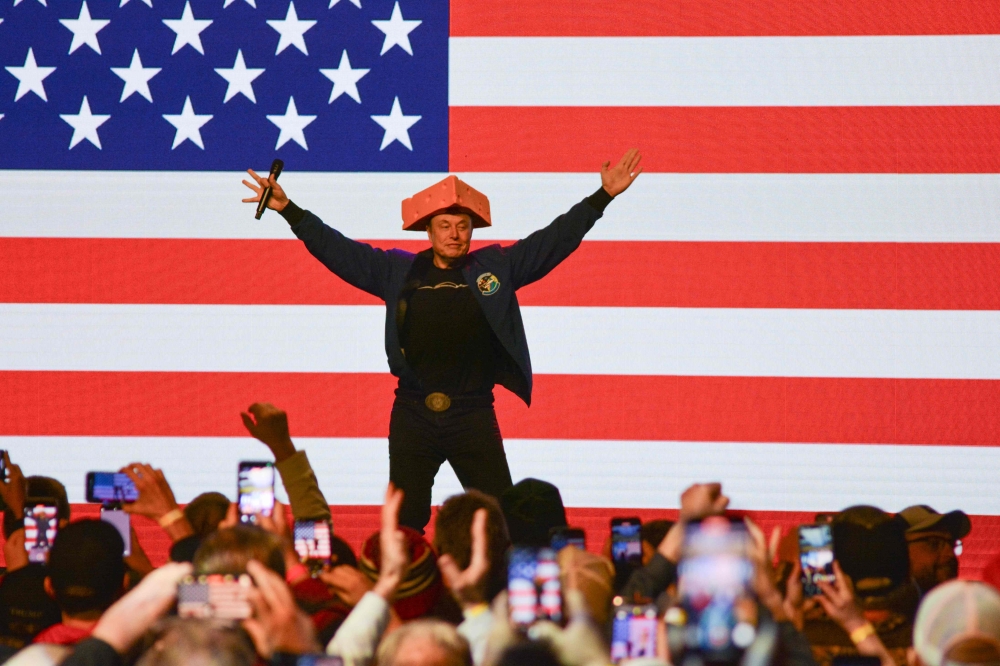 Elon Musk wears a Cheesehead hat as he speaks during a town hall in Green Bay, Wisconsin, March 30, 2025. — AFP pic