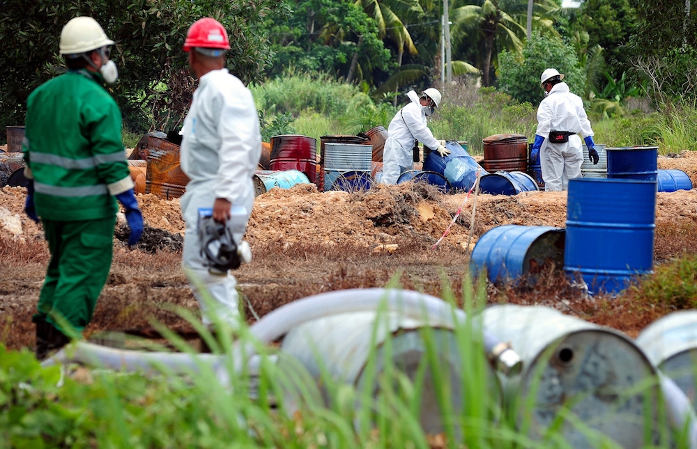 A file picture of workers from Kualiti Alam conducting checks on chemical drums in Kuala Selangor. — Bernama pic
