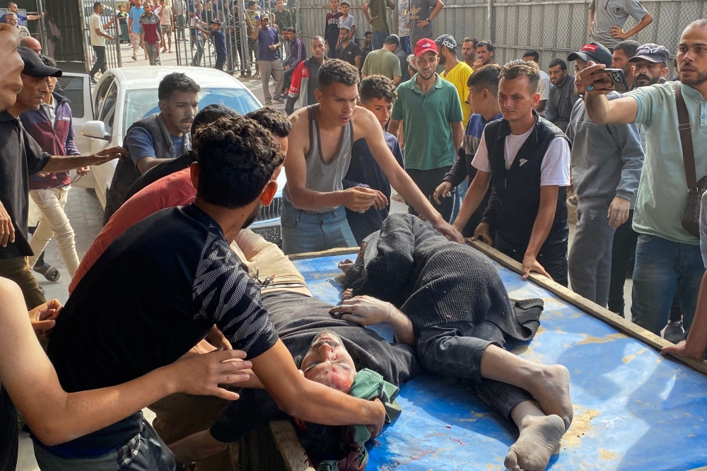 Palestinians transport people who were injured in Israeli strikes on displacement tents in Khan Yunis, to the Nasser hospital in the southern Gaza Strip on June 3, 2025. — AFP pic 