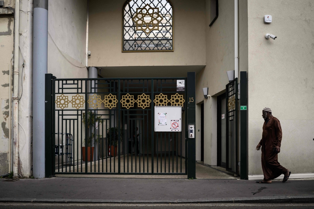 A faithful enters the Errahma mosque in Villeurbanne, central France, on June 3, 2025. A Quran was stolen and burnt at a mosque in Villeurbanne, on the outskirts of Lyon, the mosque’s owners announced on June 3, 2025. — AFP pic 
