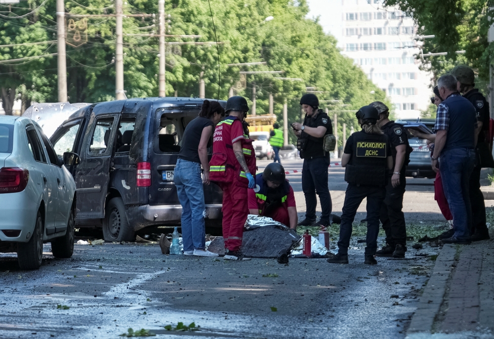 A medical worker inspects a body at the site of Russian military strike, amid Russia’s attack on Ukraine in Sumy, June 3, 2025. — Reuters pic 