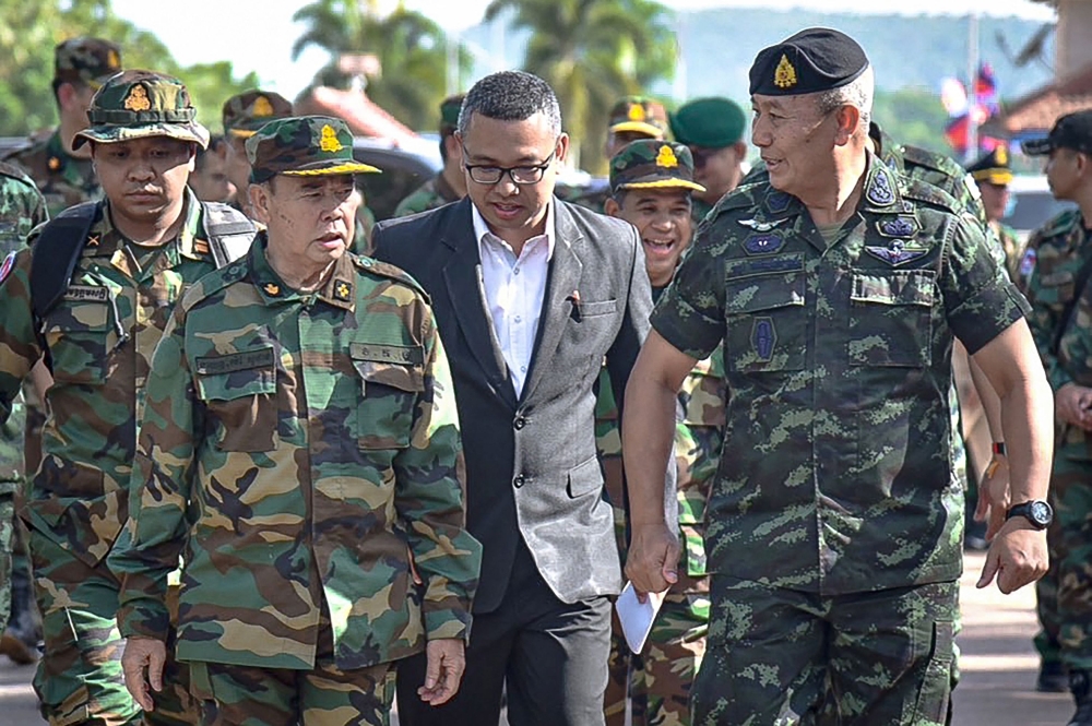 This handout picture taken and released on May 29, 2025 by the Royal Thai Army shows the Commander-in-chief of the Royal Thai Army (RTA) General Pana Klaewplodthuk (right) and the Commander of the Royal Cambodian Army General Mao Sophan (left) walking during a meeting at the Chong Chom border crossing in Thailand’s Surin province. — Royal Thai Army handout pic via AFP 