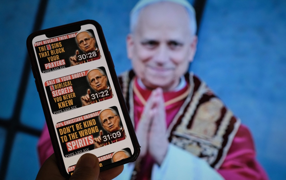 This illustration photo taken on June 3, 2025, in Los Angeles shows a YouTube account posting AI-generated deepfake audios of Pope Leo XIV in front of a TV screen. — AFP pic