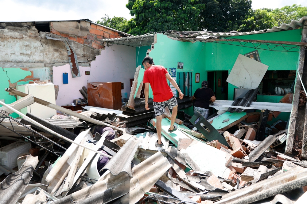 A man walks over the rubble of a house after an earthquake in Paratebueno, Cundinamarca department, Colombia June 8, 2025. — AFP pic