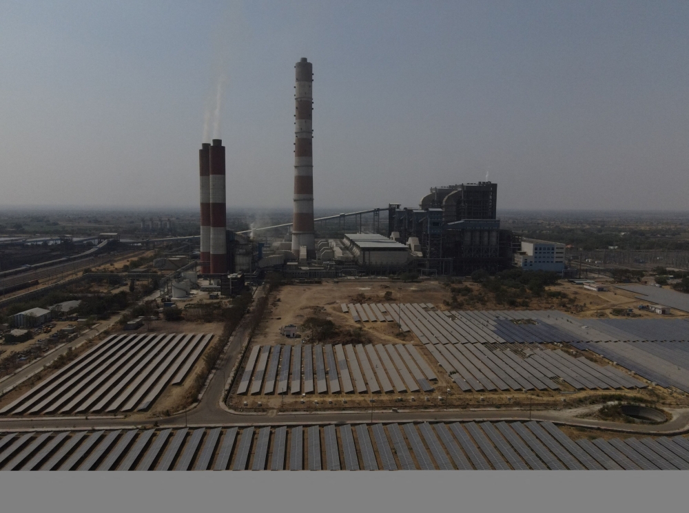A drone view of solar panels and the NTPC (National Thermal Power Corporation) power plant in Solapur, India, March 2, 2025. — Reuters pic