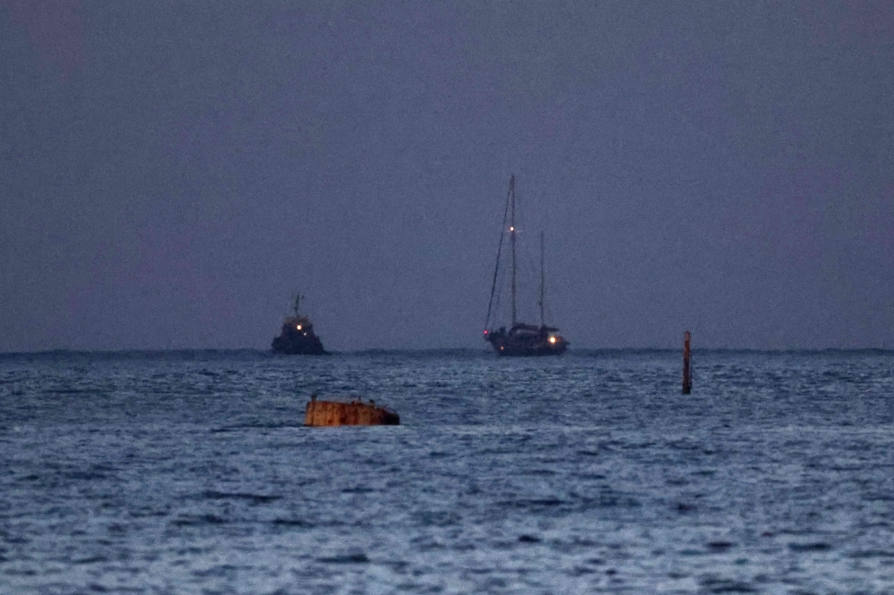 A picture shows the aid sailboat Madleen escorted by an Israeli military boat approaching the southern port of Ashdod on June 9, 2025. Israeli forces intercepted the Gaza-bound aid boat Madleen, operated by the Freedom Flotilla Coalition activist group, on June 9, preventing the activists on board from reaching the blockaded Palestinian territory. — AFP pic 