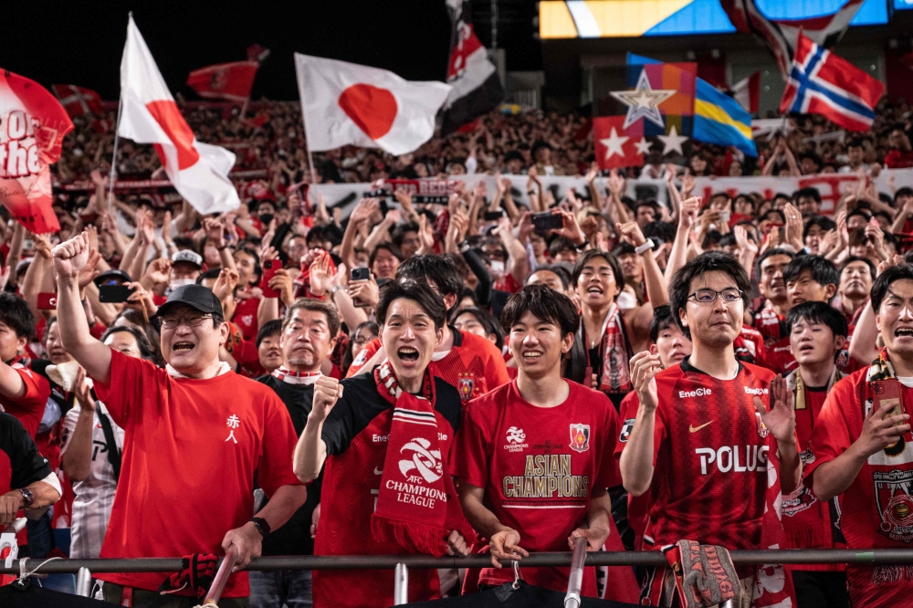 Urawa Red Diamonds fans celebrate in the stands after their team’s victory against Al-Hilal in the second leg of the AFC Champions League final at Saitama Stadium in Saitama on May 6, 2023. Their raucous fans are the self-styled bad boys of Japanese football and the team’s red shirts, white shorts and black socks bear more than a passing resemblance to Manchester United. — AFP pic 