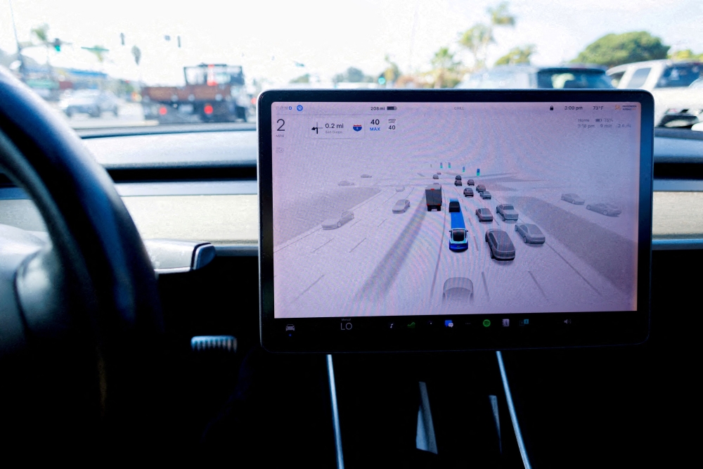 A Tesla Model 3 vehicle drives using FSD (Full Self-Driving) in Encinitas, California, October 18, 2023. Tesla tentatively plans to begin offering rides on its self-driving robotaxis to the public on June 22, CEO Elon Musk said yesterday. — Reuters pic