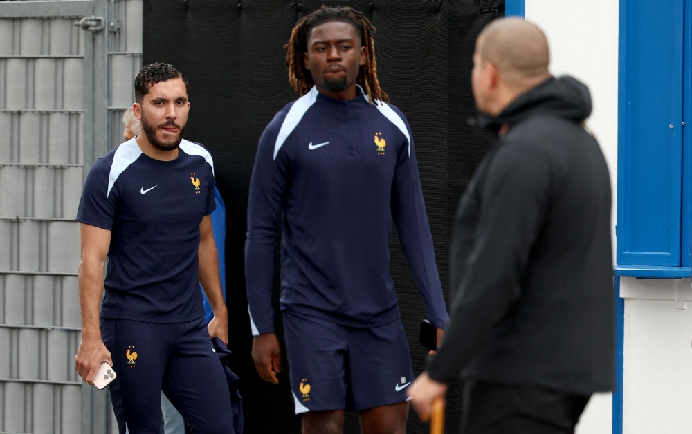 France's forward #25 Rayan Cherki (L) France's midfielder #13 Manu Kone (C) arrive to attend a training session of France's national football team in Bietigheim near Stuttgart, southwestern Germany on June 7, 2025. — AFP pic