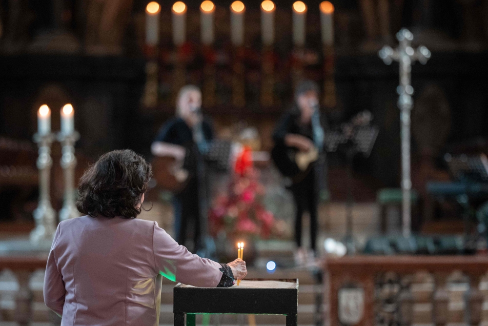 A woman lights a candle in Vienna's St Stephen's Cathedral (Stephansdom) in respect for the victims of the 