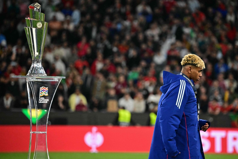 Spain’s forward #19 Lamine Yamal walks past the trophy after the Uefa Nations League final football match between Portugal and Spain in Munich, southern Germany on June 8, 2025. — AFP pic