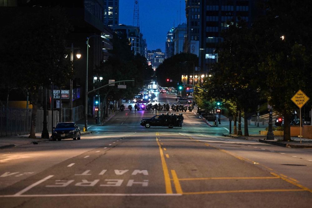 Police are seen in an empty street of downtown Los Angeles after a second night of curfew went into effect on June 11, 2025. — AFP pic