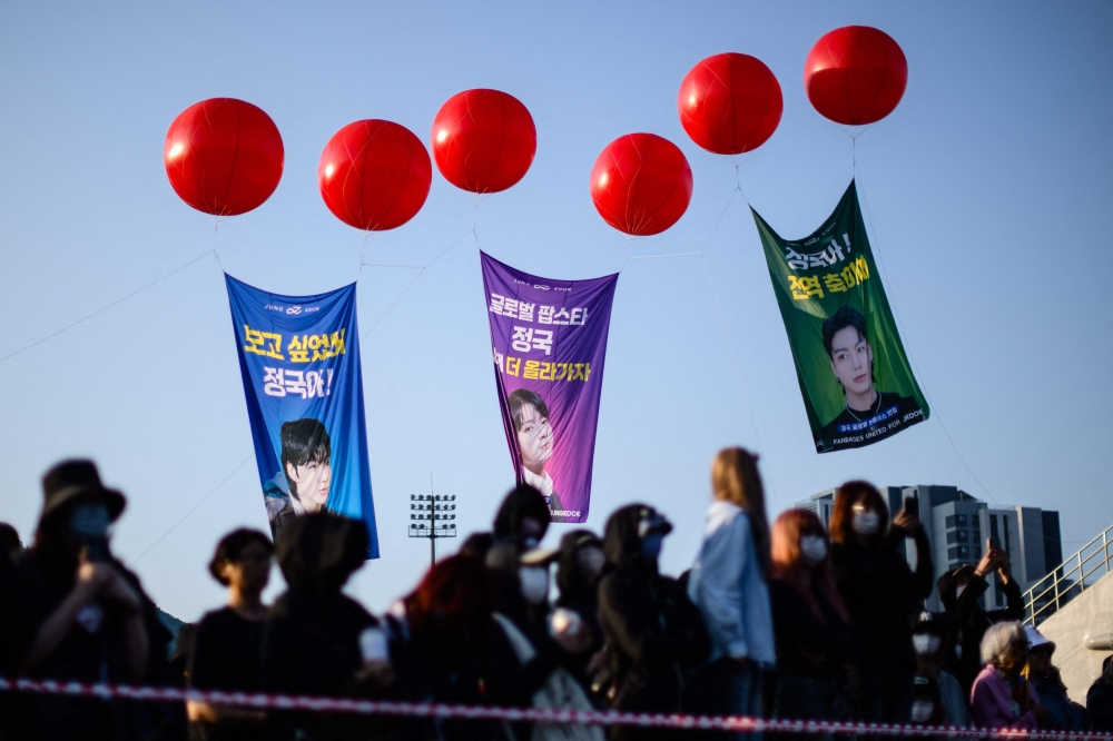 Fans of K-pop boy band BTS wait for members Jimin and Jungkook at an outdoor sporting facility in Yeoncheon June 11, 2025, shortly before their release from 18 months of South Korean military service. — AFP pic