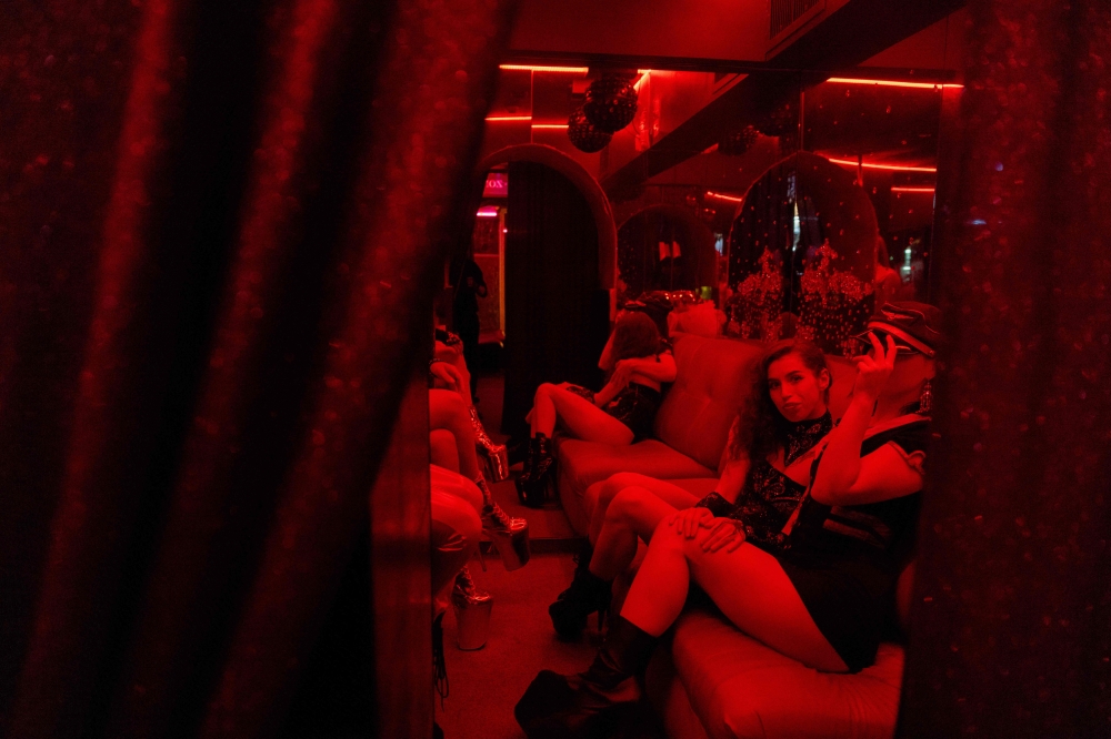 Dancers wait before performing at the strip club ‘Flash Dancers’ in Kharkiv on May 16, 2025, amid the Russian invasion in Ukraine. — AFP pic