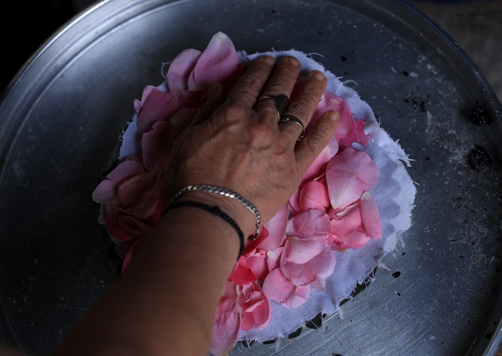 Ariana Nikolla prepares rose water in the traditional way in Permet May 28, 2025. — AFP pic