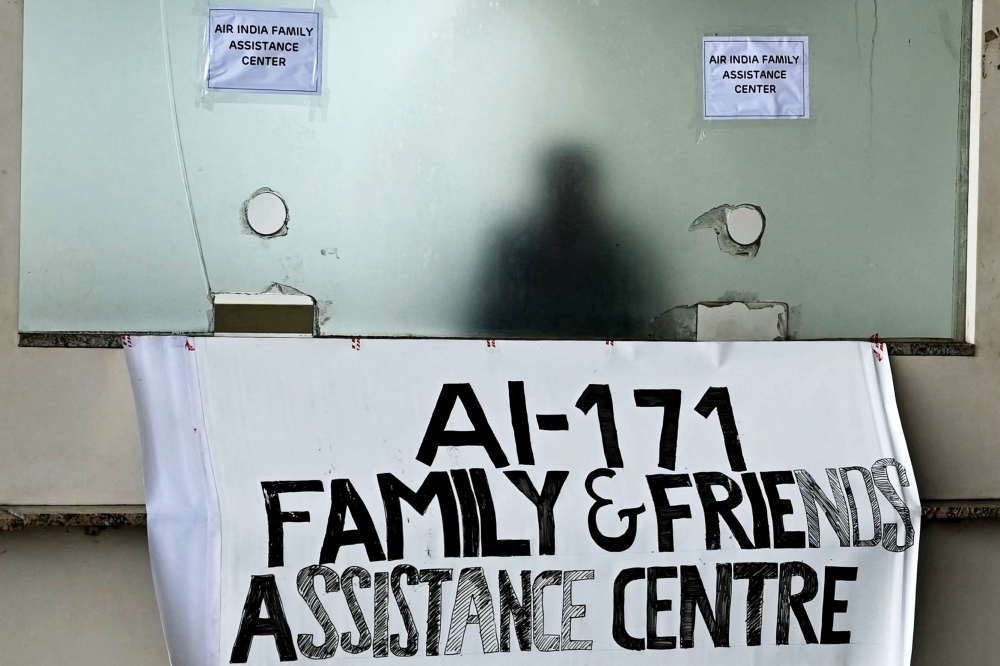 An Air India staff is pictured inside an assistance centre at the airport in Mumbai on June 13, 2025, after Air India flight 171 crashed the previous day at a residential area in Ahmedabad. — AFP pic