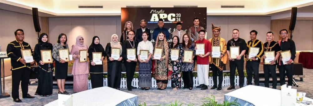 Datuk Mohd Hanafiah Mohd Kassim (back row, second from left) and Datuk Ariffin Mohd Arif (back row, middle) with the Sabah government award recipients. — The Borneo Post pic