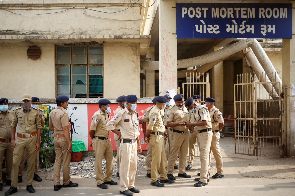 Policemen stand guard outside the post mortem room, where the bodies of the victims who died after the Air India Boeing 787-8 Dreamliner plane bound for London's Gatwick Airport crashed during take-off from Ahmedabad have been kept, at a hospital, in Ahmedabad June 14, 2025. — Reuters pic 
