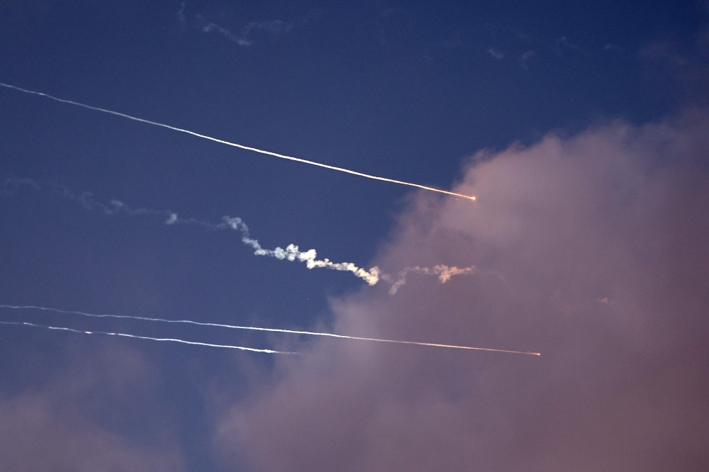 This photo shows rocket trails and intercepts in the sky over the Israeli city of Netanya on June 14, 2025. — AFP pic