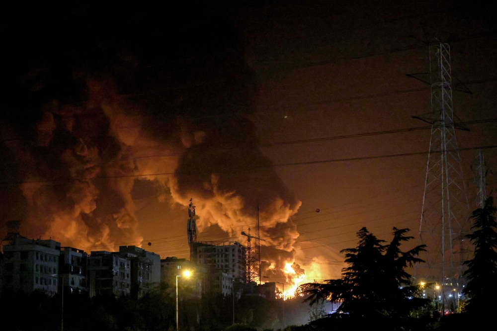 A fire blazes in the oil depots of Shahran, north-west of Tehran, on June 15, 2025. Israel and Iran exchanged fire on June 14, a day after Israel unleashed an unprecedented aerial bombing campaign that Iran said hit its nuclear facilities, ‘martyred’ top commanders and killed dozens of civilians. — AFP pic