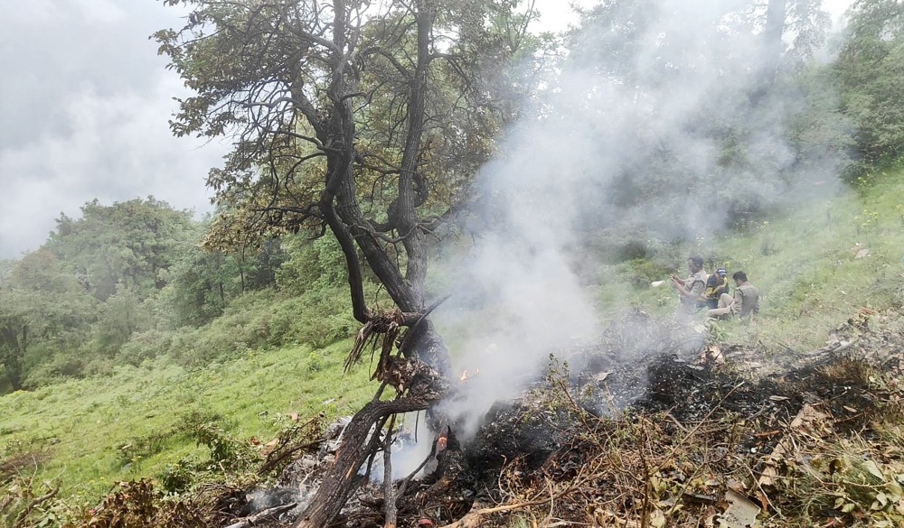 This handout photograph taken on June 15, 2025 and released by the State Disaster Response Force (SDRF) of India’s Uttarakhand state shows smoke billowing from the site of a chopper crash near Gaurikund. Seven people including a toddler were killed on June 15, in India when a helicopter ferrying Hindu pilgrims back from a shrine crashed in the Himalayas, officials said. — Uttarakhand’s State Disaster Response Force handout/AFP pic