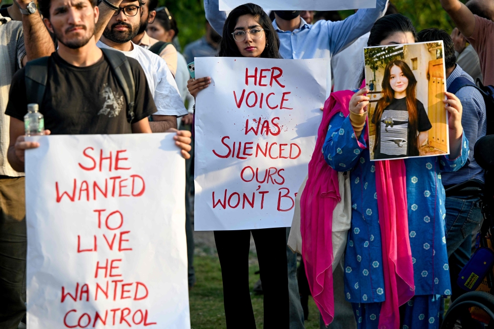 Demonstrators hold placards and a poster of TikTok star Sana Yousaf during a protest held to condemn violence against women after she was killed for rejecting a man’s proposal in Islamabad June 5, 2025. — AFP pic
