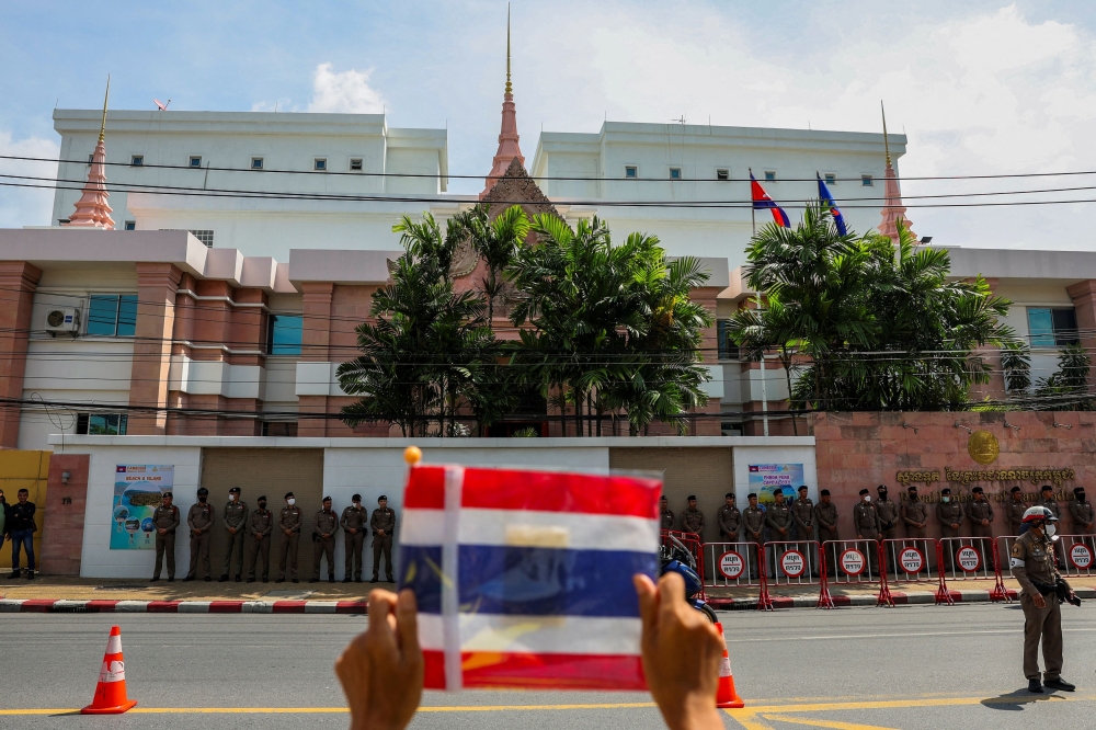 A royalist activist holds a Thai flag as he protests in front of the Royal Embassy of Cambodia, following a recent clash at the Thailand-Cambodia border on May 28, 2025, in Bangkok June 6, 2025. — Reuterse pic