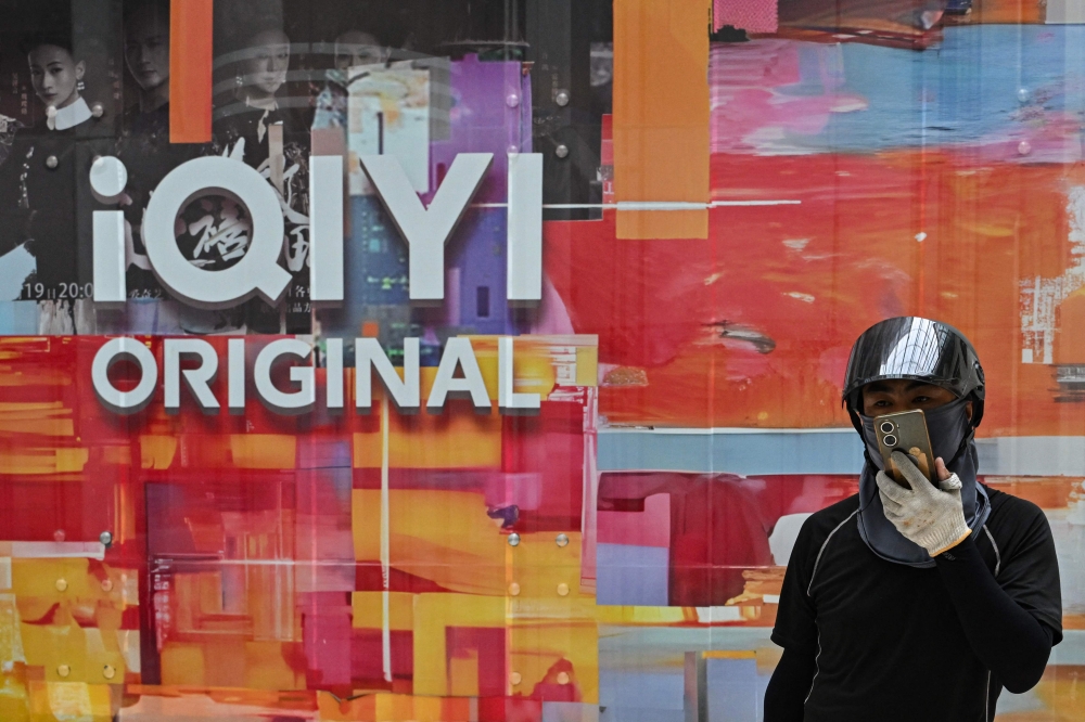 A man walks past the headquarters of the world’s largest online video website iQIYI, in Beijing, China on June 13, 2025. — AFP pic