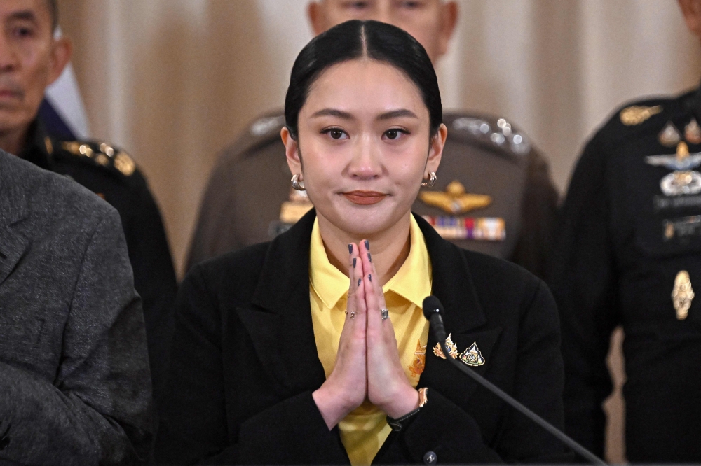Thailand’s Prime Minister Paetongtarn Shinawatra gestures during a press conference surrounded by senior Thai army commanders and government minsters at Government House in Bangkok June 19, 2025. — AFP pic