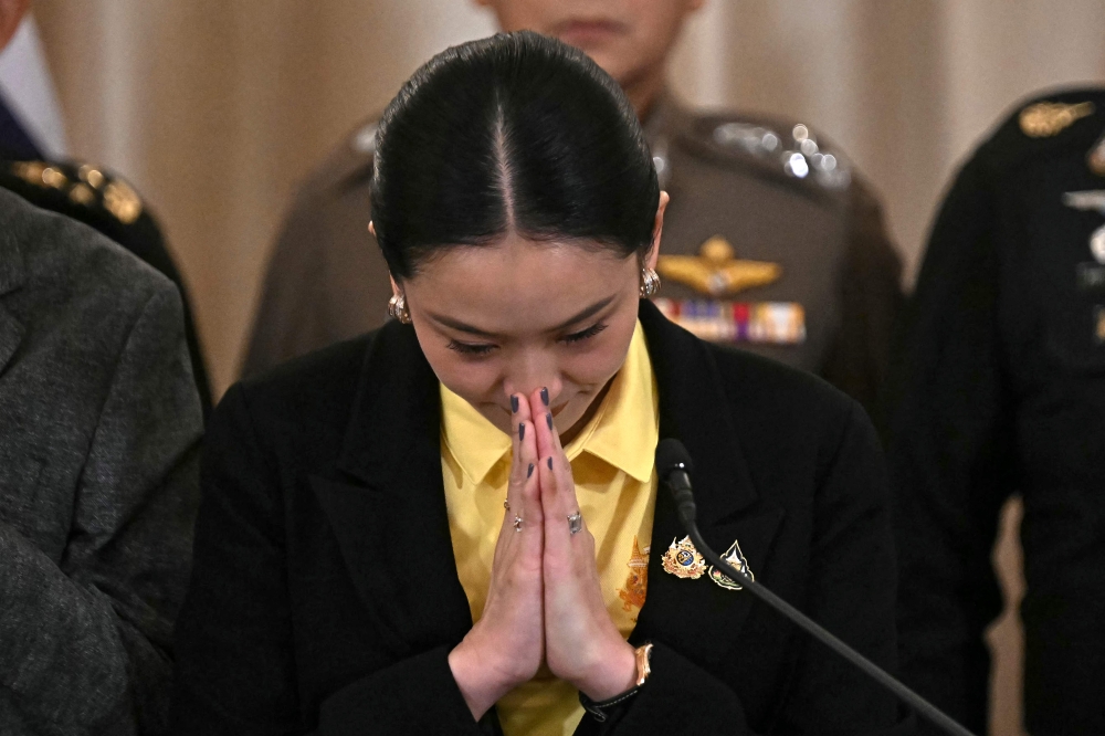 Thailand's Prime Minister Paetongtarn Shinawatra (centre) gestures during a press conference surrounded by senior Thai army commanders and government minsters at Government House in Bangkok June 19, 2025. — AFP pic 