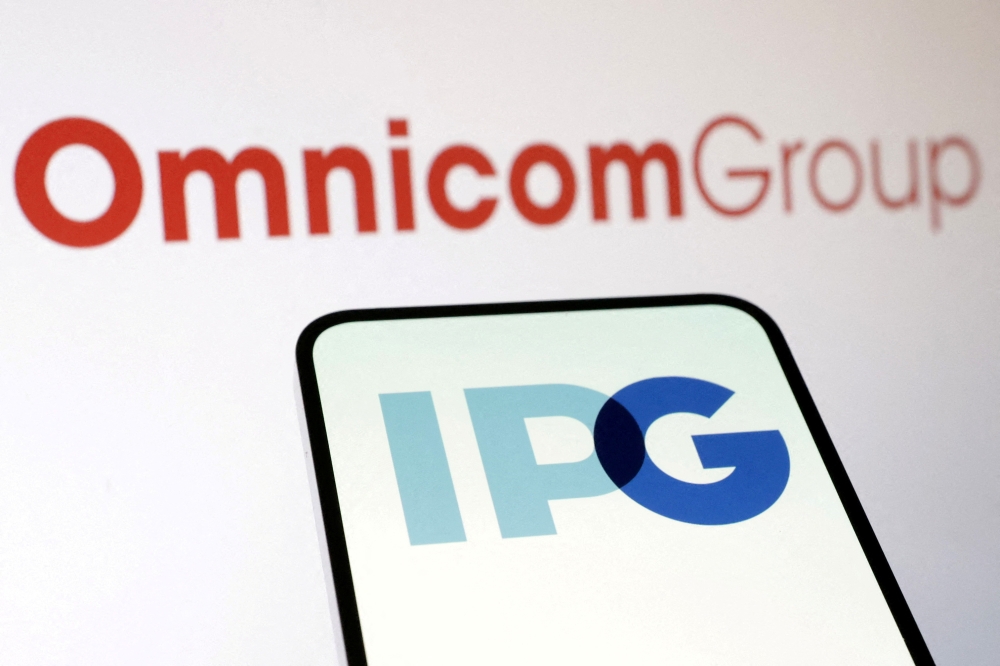 Omnicom Group and Interpublic Group logos are seen in this illustration taken December 9, 2024. — Reuters pic 
