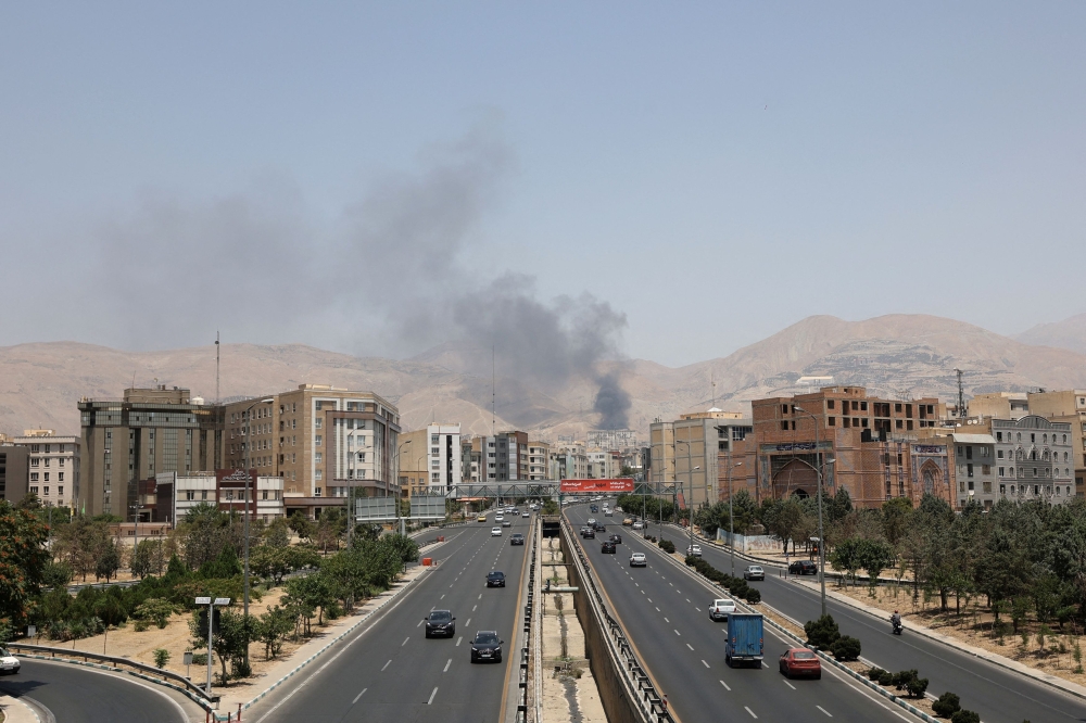 Smoke rises following what Iran says was an Israeli attack on Sharan Oil depot in Tehran June 16, 2025. — Majid Asgaripour/Wana (West Asia News Agency) pic via Reuters