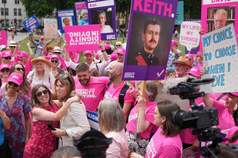 Campaigners for a change in the law on assisted dying celebrate outside The Palace of Westminster, home to the Houses of Parliament in central London, June 20, 2025, after the vote to allow assisted dying for terminally ill people. — AFP pic