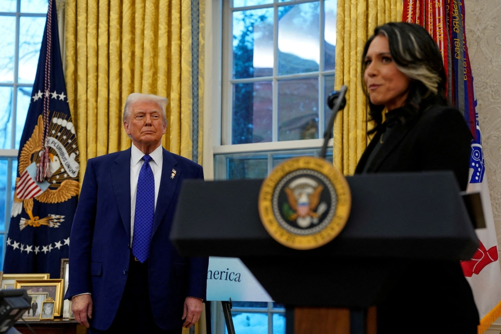 This file photo shows US President Donald Trump looking at Director of National Intelligence Tulsi Gabbard, on the day of Gabbard's swearing in ceremony, in the Oval Office at the White House in Washington, DC, US February 12, 2025. — Reuters