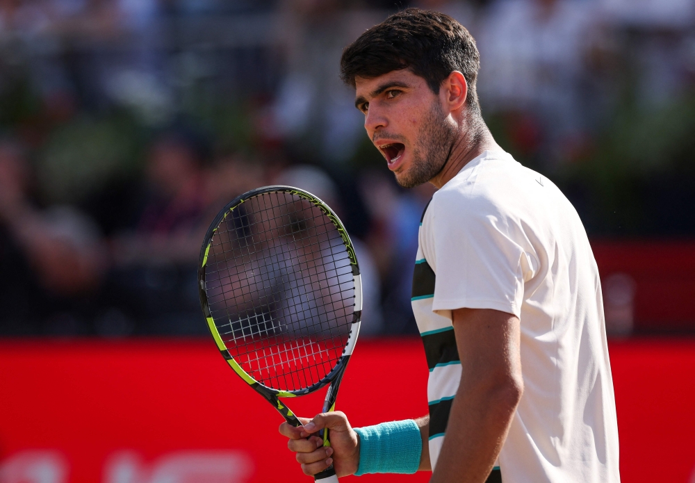 Spain’s Carlos Alcaraz celebrates winning against compatriot Roberto Bautista-Agut during their men’s singles semi-final match at the HSBC ATP Championships at Queen’s Club in London June 21, 2025. — AFP pic